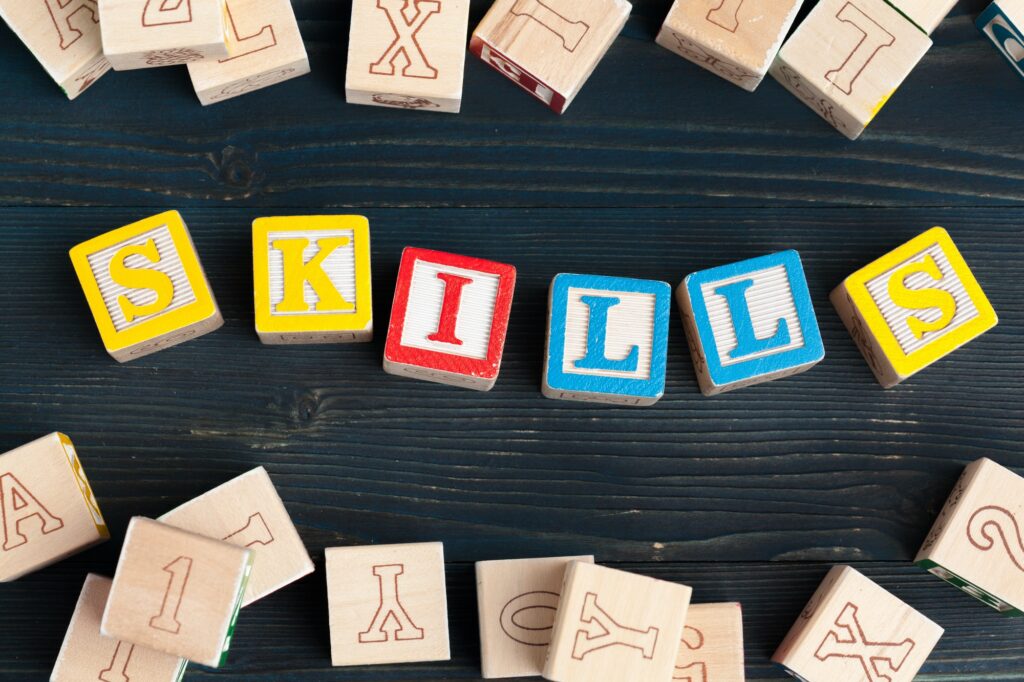 Alphabet blocks ABC on wooden table. Text - skills