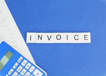 calculator and receipt with the word invoice.
