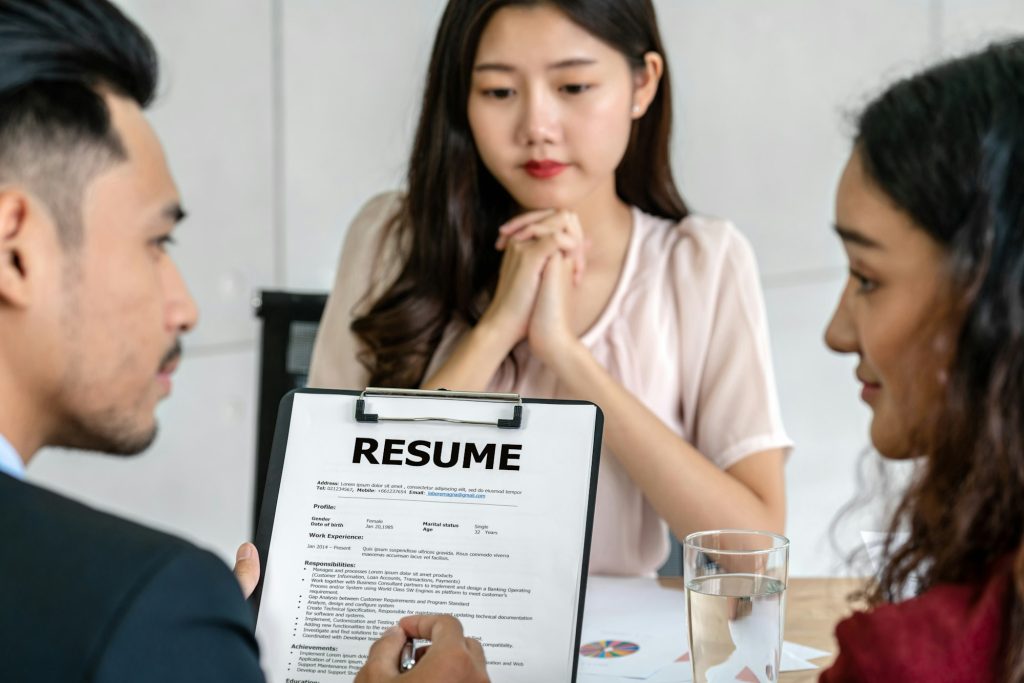 Closeup Resume in two manager hand holding when discuss about her resume with serious motion