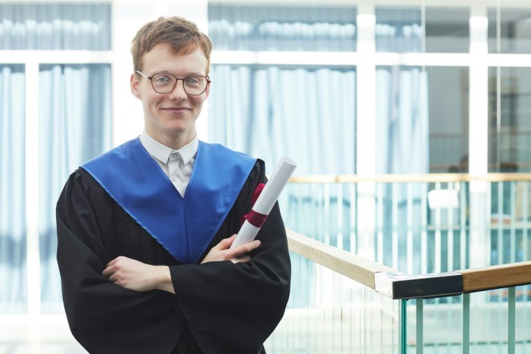 Young man holding diploma