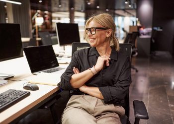 A Confident and Professional Individual Thriving in a Modern Collaborative Workspace Environment