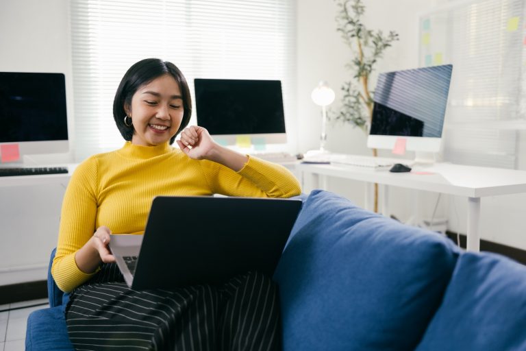 Asian freelancer working on laptop from home office