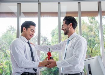 boss presented an award for outstanding man employees