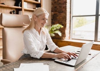 Boss working, typing on laptop computer searching information, social media watching webinars online