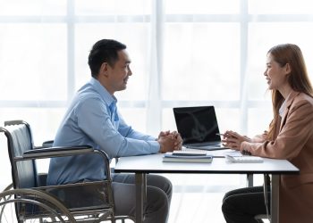 Business woman talk with male job applicant at interview.