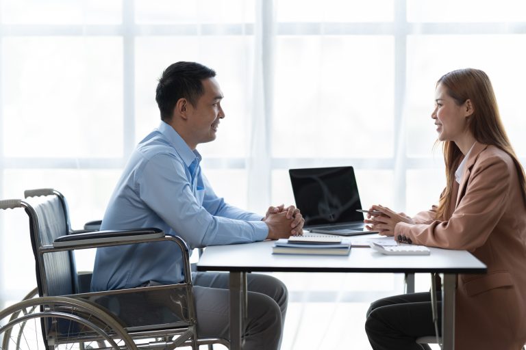 Business woman talk with male job applicant at interview.