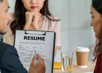 Closeup Resume in two manager hand holding when discuss about her resume