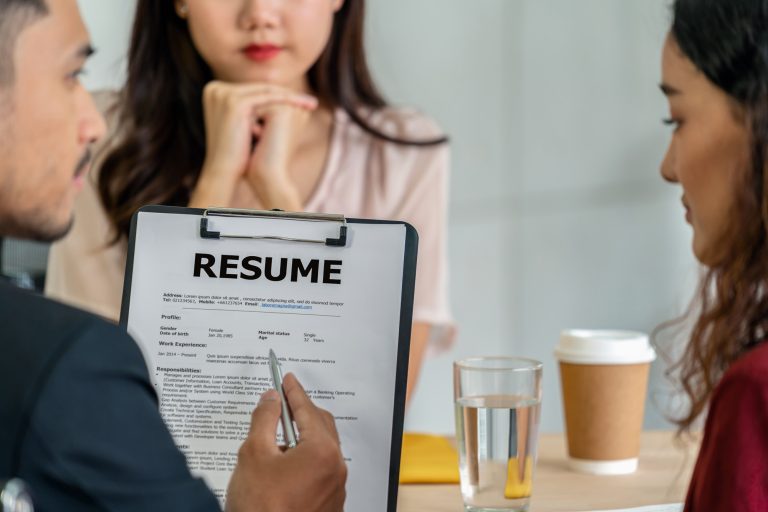 Closeup Resume in two manager hand holding when discuss about her resume