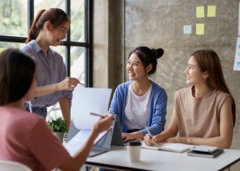 Creative young Asian business woman meeting to plan events. Take note of the job description