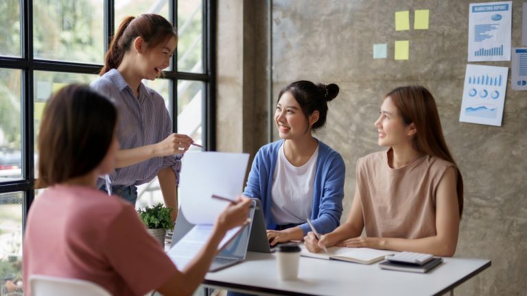 Creative young Asian business woman meeting to plan events. Take note of the job description