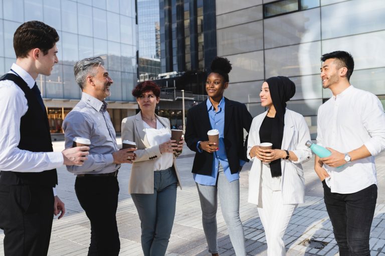 Diverse Business Professionals Networking Outdoors with Coffee