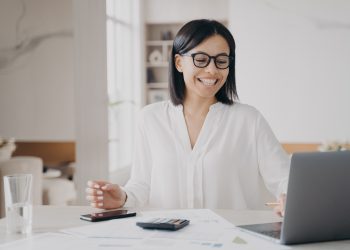 Happy female employee working at laptop got email with good news. Job promotion, successful deal