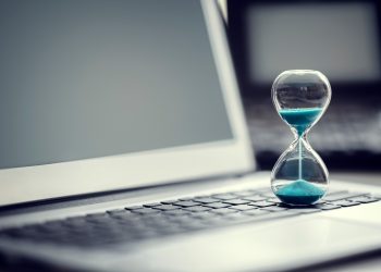 Hourglass on laptop computer concept for time management