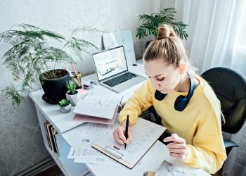 How to Make Create Resume. Young woman student writing resume or cv letter for applying for a job