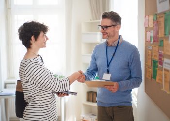 Job centre employee meeting young woman searching for job.