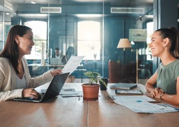 Job interview for a business woman at a hiring company talking to the HR manager about the role or
