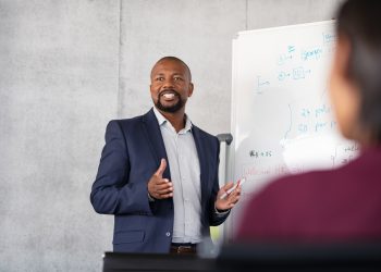 Mature african businessman training employees