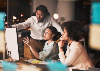 Meeting, late night and business people at computer with problem solving, ideas and planning startu