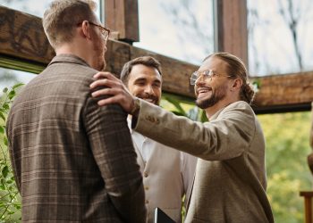 merry good looking business leaders with glasses in sophisticated attires working on their startup