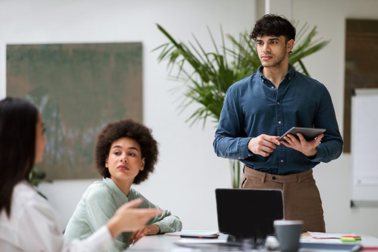 Middle Eastern Businessman Presents Startup Strategy to Team At Office