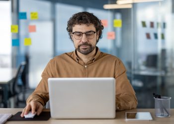 Professional working on a laptop in a modern office