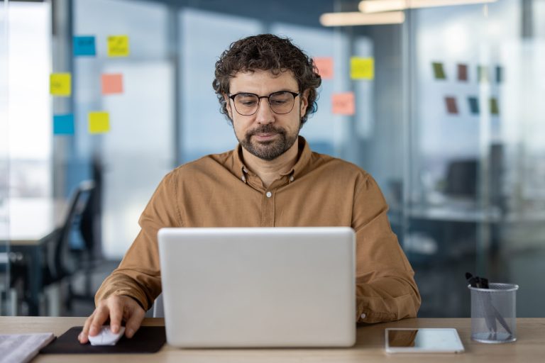 Professional working on a laptop in a modern office