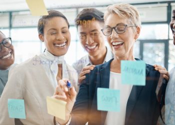 Teamwork, planning and strategy with a business woman, manager or CEO working with a team on a glas