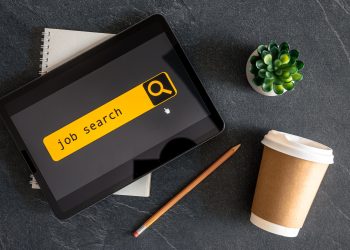 Top view of digital tablet with search job on screen.