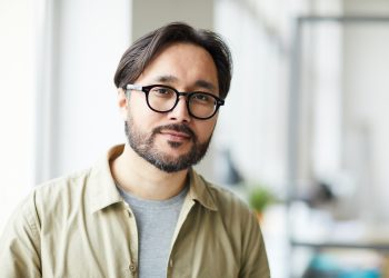 Young Asian employee in office