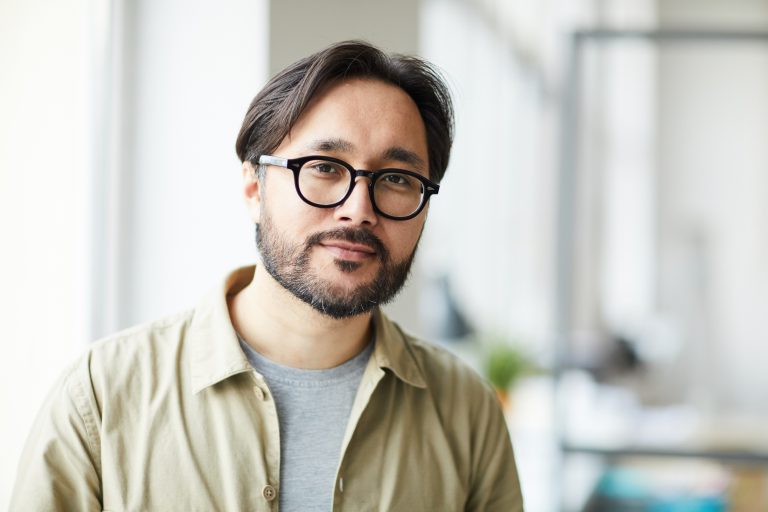 Young Asian employee in office