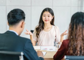 Young Asian woman graduate interviewing with two manager