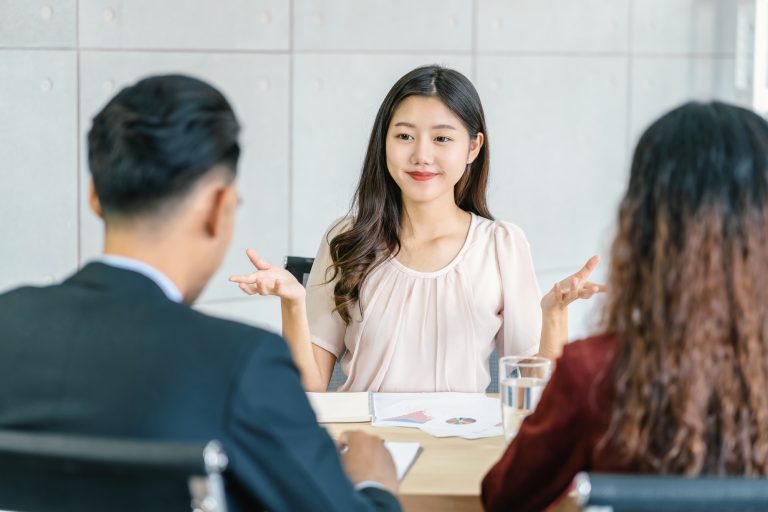 Young Asian woman graduate interviewing with two manager