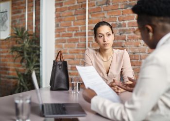 Young woman having job interview at corporate office.