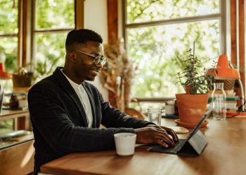 Adult man, making sure his resume is well written.
