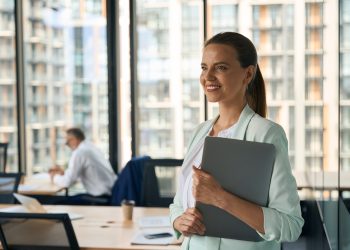 Ambitious lady at office smiling and anticipating career growth