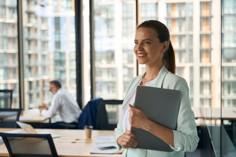 Ambitious lady at office smiling and anticipating career growth