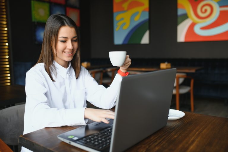 Confident business woman searching resume on site via laptop computer