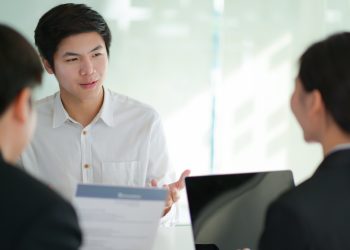 Interviewing job seekers presenting their resume for executives to consider.