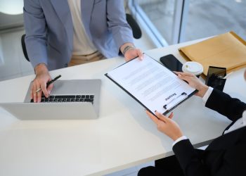 Job candidate handing over her resume during job interview